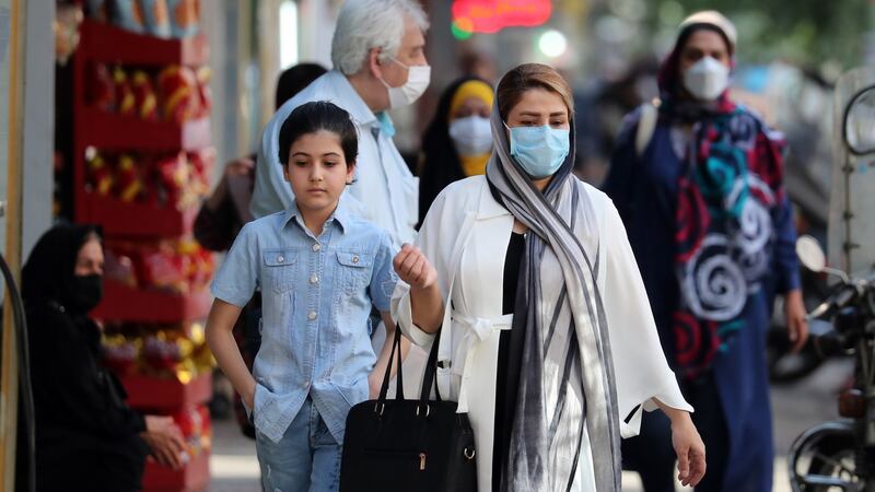 Iranians wearing face masks on a street in Tehran. Photograph: Aref Taherkenareh/EPA