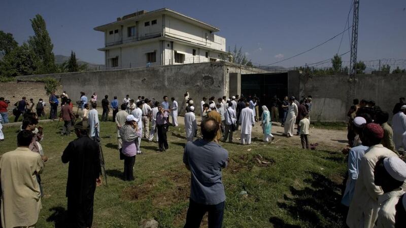 Local people and media gather outside the perimeter wall and sealed gate into the compound and a house where al-Qaeda leader Osama bin Laden was  killed on Tuesday, May 3, 2011.  Photograph: Anjum Naveed/AP