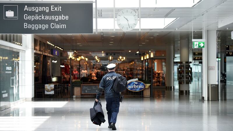 A police officer walks through a near-empty Lufthansa terminal at Franz-Josef-Strauss airport in Munich. Photograph: AFP via Getty