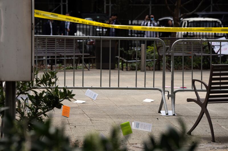 Pamphlets litter the pavement at the scene where a man set himself on fire outside of the Manhattan Criminal Courts building in New York. Photograph: Maansi Srivastava/The New York Times
                      