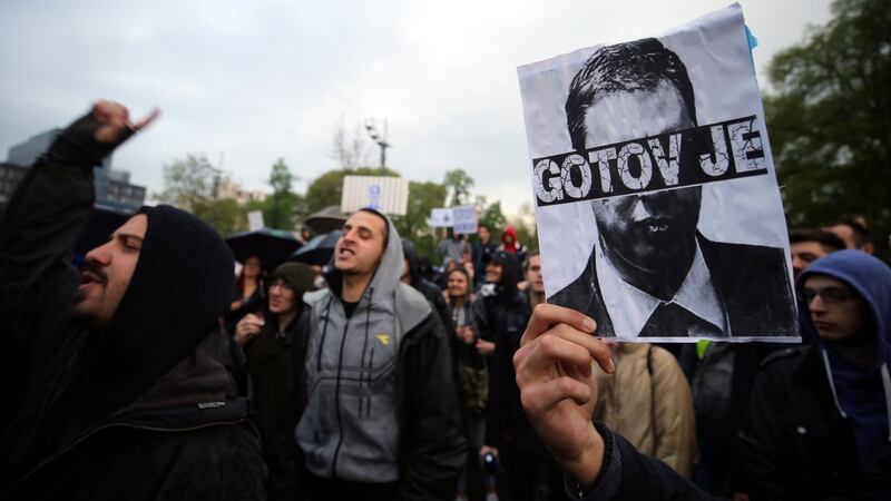 Protesters hold an image of newly elected president Aleksandar Vucic with the words “It’s over”, in Belgrade, Serbia  on Wednesday. Photograph: Koca Sulejmanovic