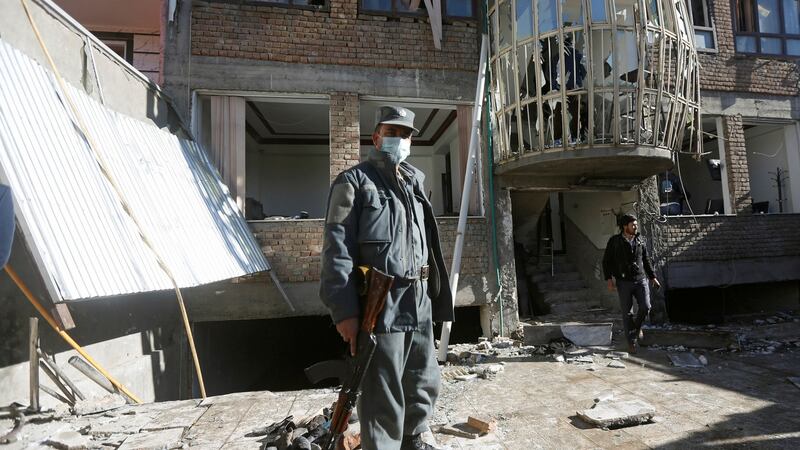 An Afghan policeman keeps watch at the site of the suicide attack in Kabul. Photograph: Reuters