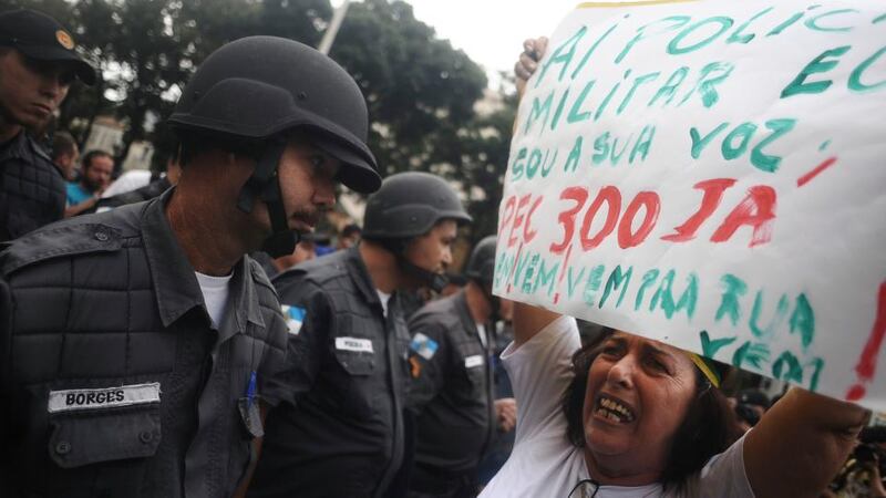 A woman protests in front of riot police during a protest on the streets near the Maracanã  stadium in Rio de Janeiro yesterday.  Photograph: Reuters/Lunae Parracho