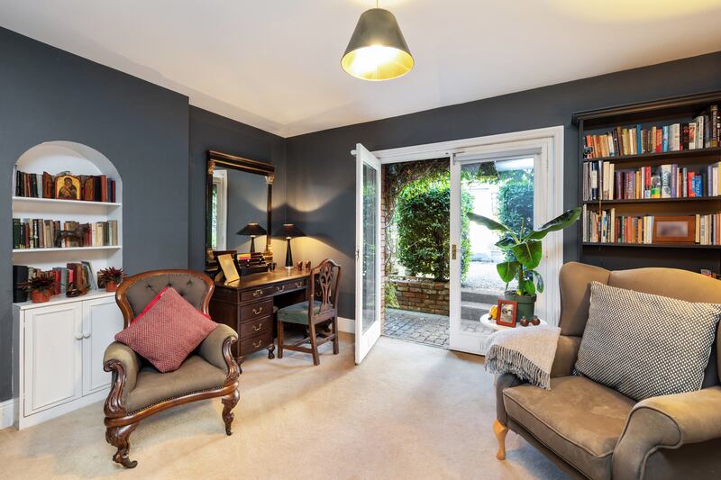 The room has double doors that open on to a beautifully maintained back garden