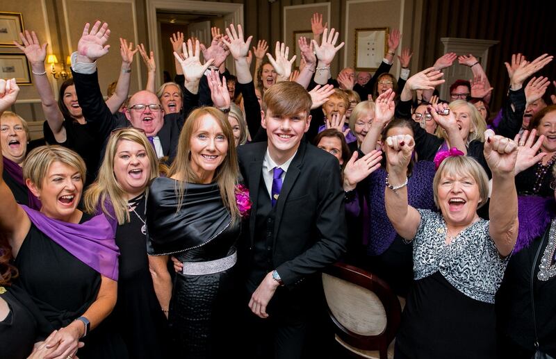 Matthew McCartin (17) from Co Wexford is congratulated by his mother Martina  and members of the Unsung Heroes Family Carers Choir during the Netwatch Carer of the Year awards at the Westin Hotel in Dublin. Photograph: Gareth Chaney/Collins