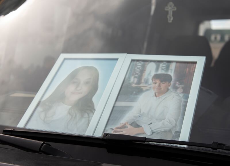 Portraits of 15-year-olds Danylo Nikytskyi and Alina Kutsenko, who were killed in the Russian air strike on Kryvyi Rih last Friday, placed on a car during their funeral on Monday. Photograph: Maxym Marusenko/EPA-EFE