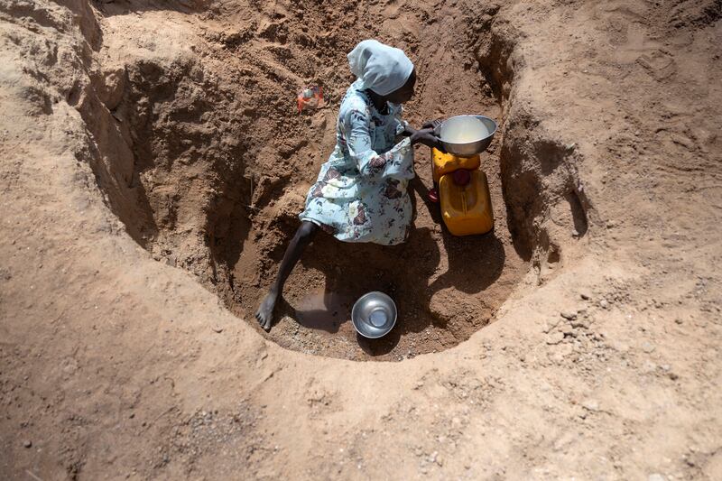A young girl digs for water outside the Farchana refugee camp in Chad. Photograph: Chris Maddaloni