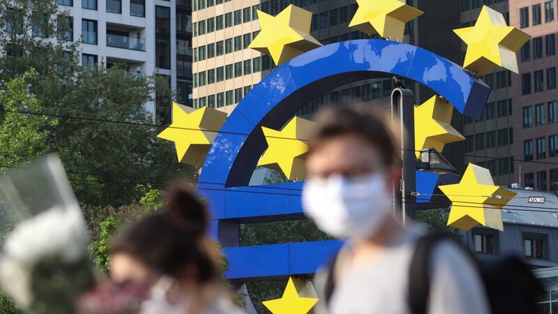 People in face masks in Frankfurt, pictured in front of the European Central Bank headquarters. Photograph: Yann Schreiber/Getty/AFP