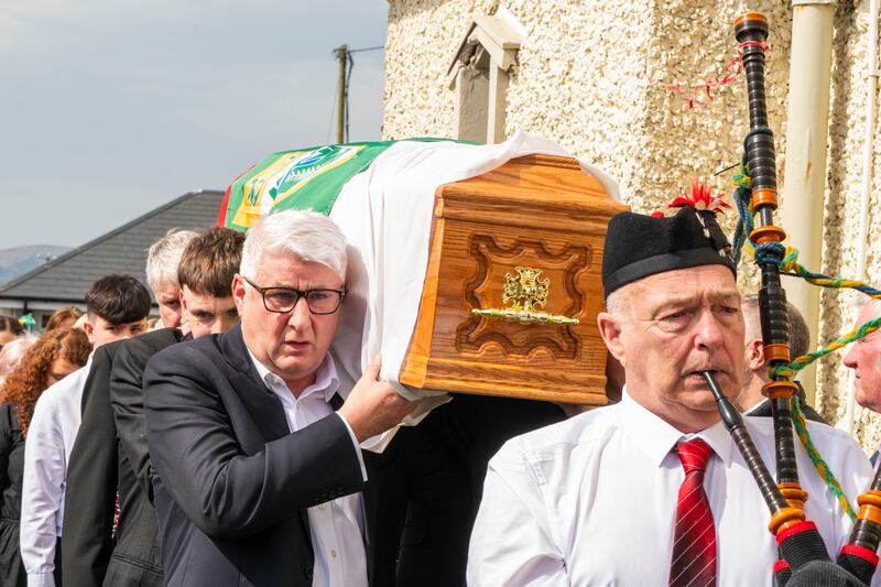 John O'Dwyer and Micko's grandsons carying the coffin, led by piper Dermot Walsh. Photograph: Noel Sweeney/PA Wire