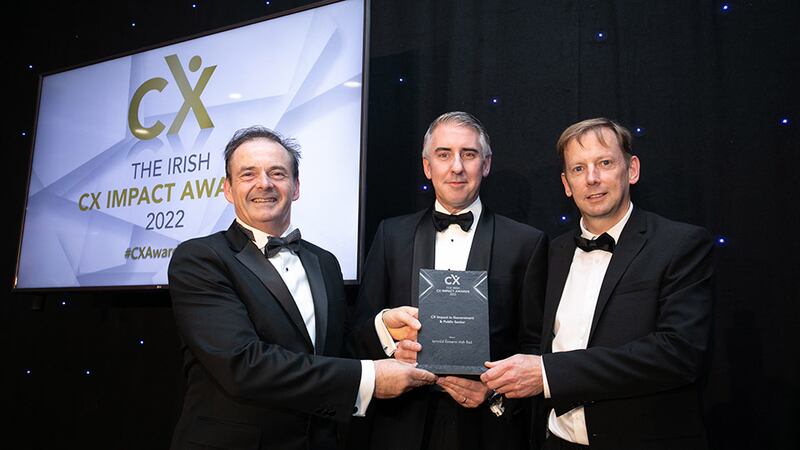 Paul Allen, awards judge, presents the CX Impact in Government & Public Sector award to Ronan Murphy and Liam Kenny, Iarnród Éireann.