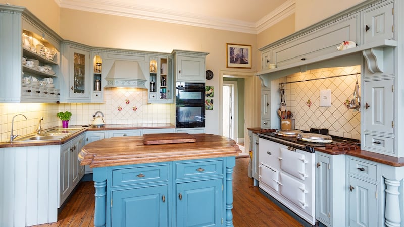Off the dining room is a cosy duck egg blue country kitchen