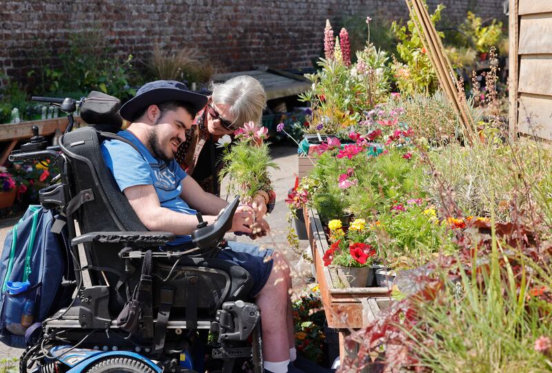 Fiona Staunton, programme support worker, with Jack in the garden centre at the Childvision Campus. Photograph: Alan Betson