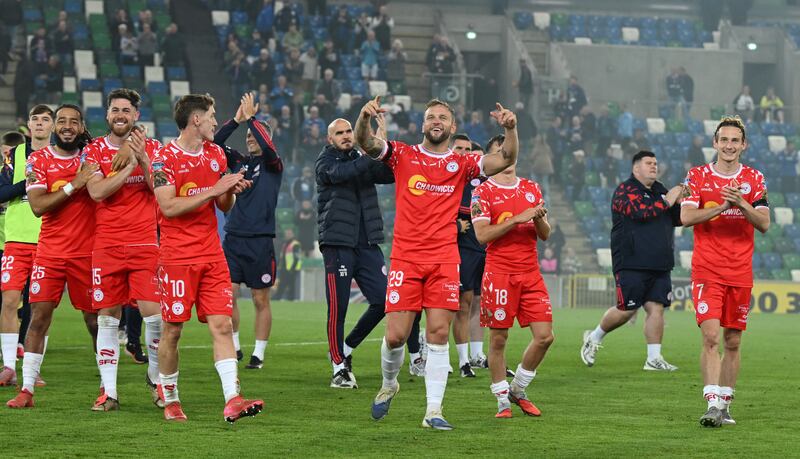 Shelbourne captain Paddy Barrett (centre) leads his teammates over to the visiting fans after Shelbourne beat Linfield 2-0 in Belfast on Thursday to secure a 5-1 aggregate victory in the Uefa Conference League. Photograph: Charles McQuillan/Getty Images
