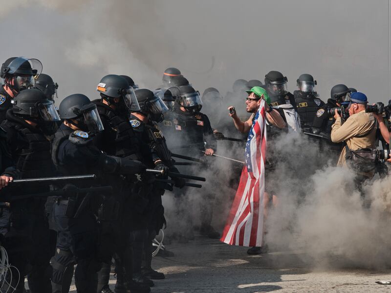 Police advance on protesters who had shut down Highway 101 in Los Angeles on Sunday, June 8th, 2025. Photograph: Philip Cheung/New York Times
                      