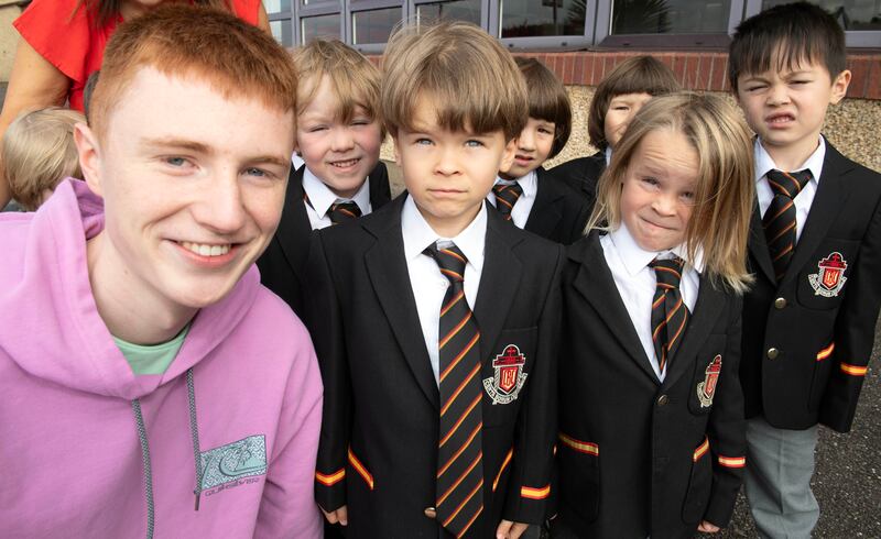 Joe Hartnett of Christian Brothers College Cork, who received seven H1s,  celebrates with students on their first day at school from CBC Infants. Photograph: Michael Mac Sweeney/Provision