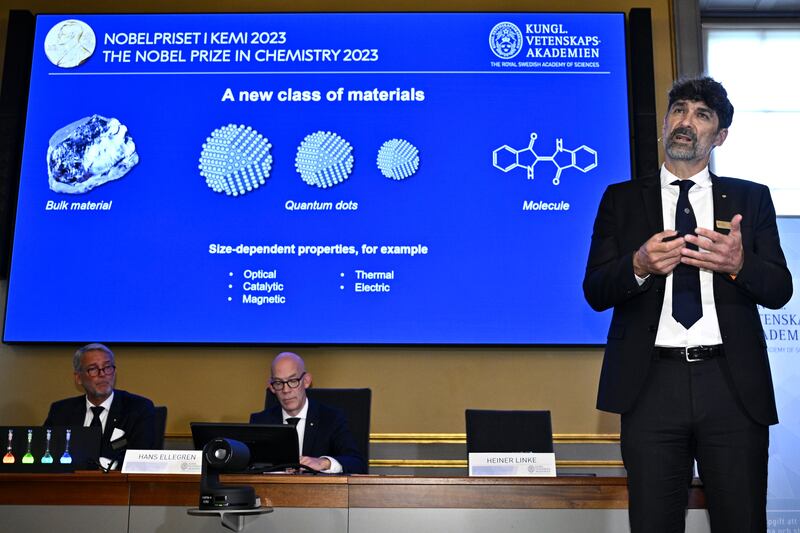 Heiner Linke  of the Nobel Committee for Chemistry presents the work of the winners of the 2023 Nobel Prize in Chemistry during a press conference at the Royal Academy of Sciences. Photograph: Claudio Bresciani/AP