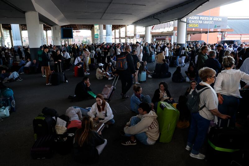 Passengers wait at the Atocha railway station,  Madrid, on Monday. Photograph: Oscar Del Pozo/Getty 
