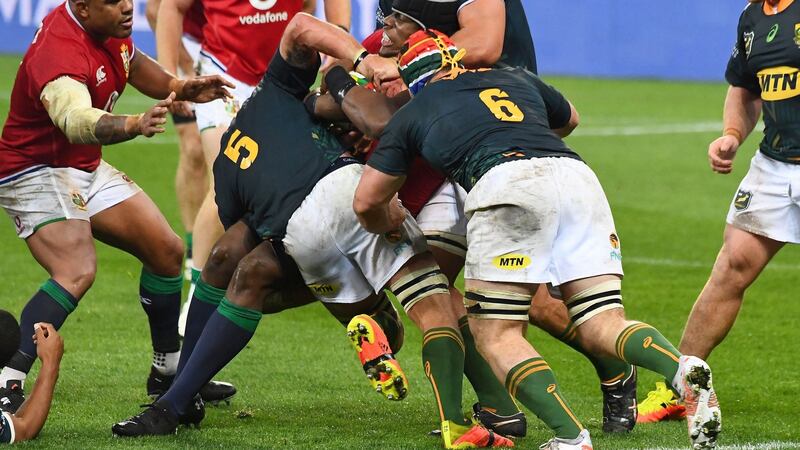 Franco Mostert  and Marco van Staden of South Africa A tackle Maro Itoje of the Lions during the game in Cape Town. Photograph:  Rodger Bosch/AFP via Getty Images