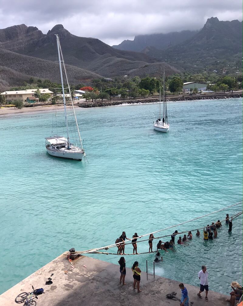 Local kids in Ua Po use the ropes tying the ship as a diving board. Photograph: Gemma Tipton