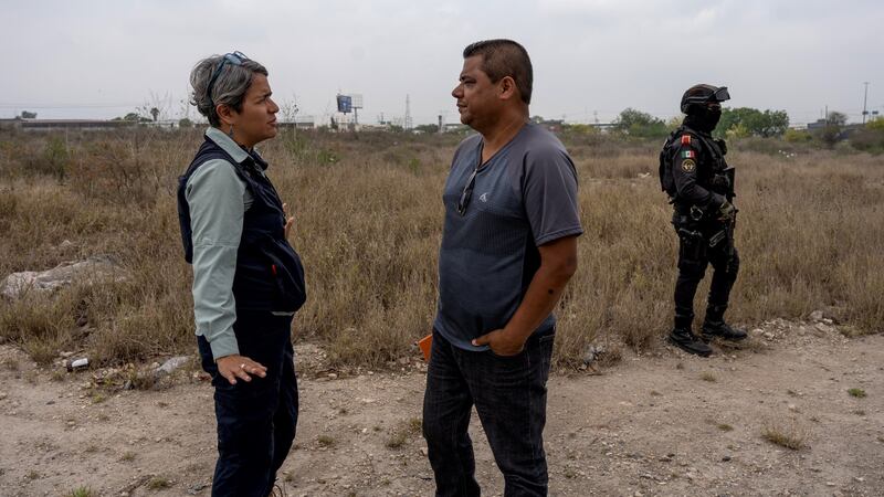 Karla Quintana, the head of the National Search Commission of Mexico, speaks with Mario Escobar on April 21st, the 13th day of a search for his daughter, Debanhi. Her  body was found later that night. Photograph: Alejandro Cegarra/New York Times
