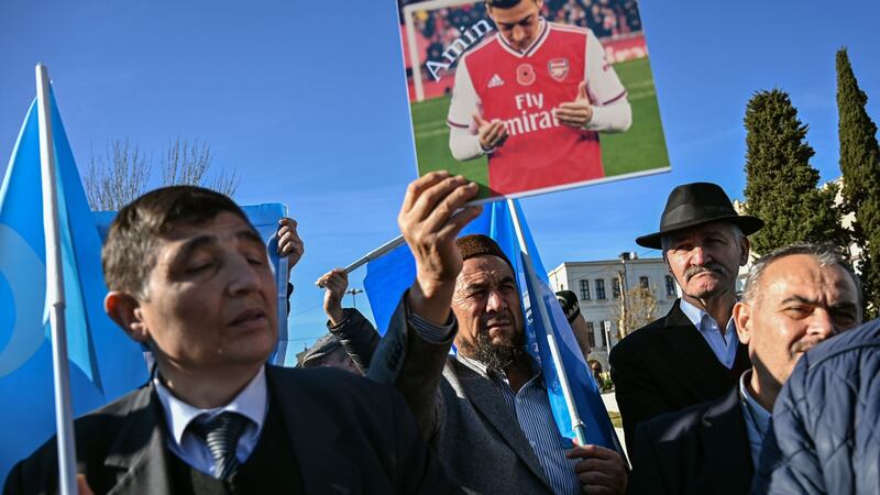 A supporter of China’s Muslim Uighur minority holds a placard of Mesut Özil in Istanbul on Saturday. Photograph: Ozan Kose/AFP