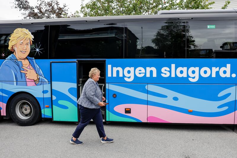 Former Norwegian prime minister and leader of Hoeyre (the Conservative Party) Erna Solberg walks past her battle bus with an image of herself, and the slogan 'no slogan', while canvassing in Bergen, western Norway. Photograph: Paul S Amundsen/NTB/AFP via Getty Images