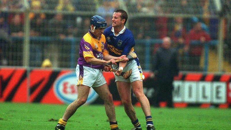 Liam Dunne of Wexford and Brian O’Meara of Tipp  had been rutting and jabbing at each other’s sides with their hurleys but that was the extent of it. They were sent off, on the linesman’s word, for striking. Photograph: Morgan Treacy/Inpho